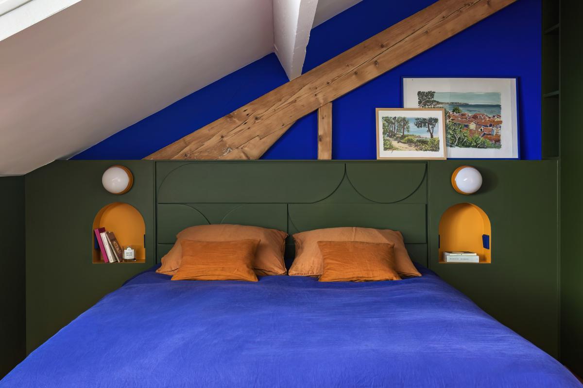 Schlafzimmer mit Dachschrägen mit olivfarbenem Kopfteil aus Holz und Wand Bleu Klein