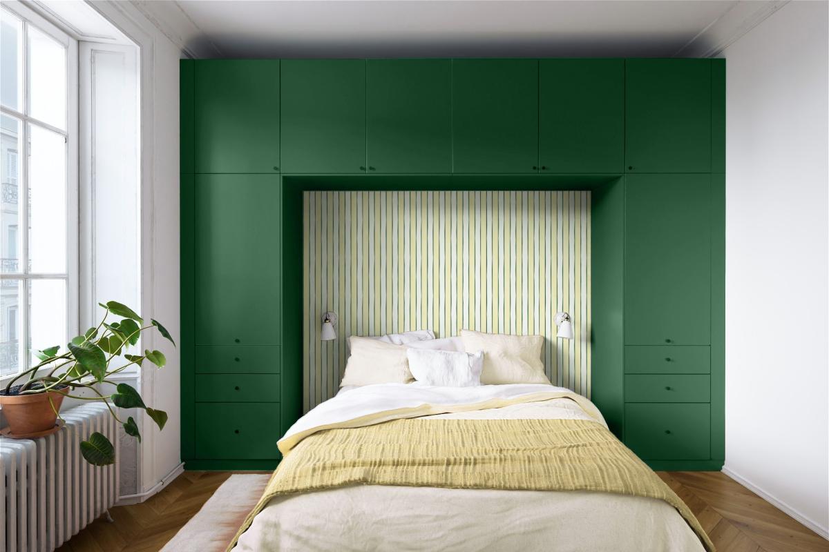 Green headboard with yellow striped wallpaper