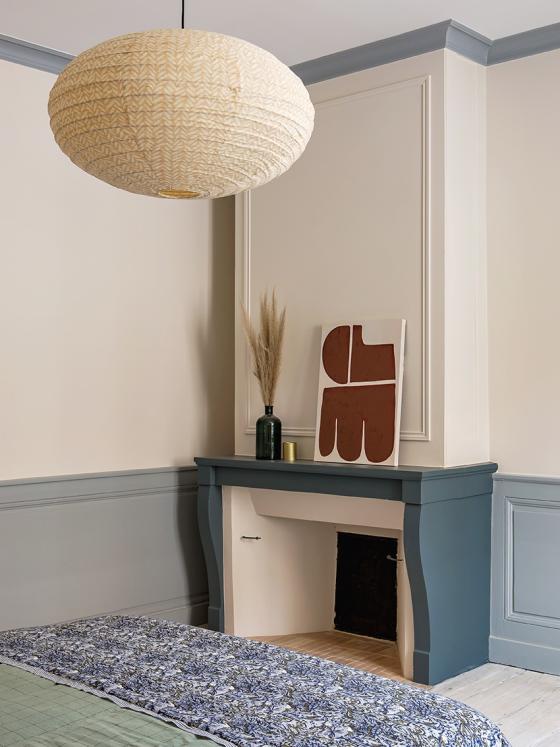Chambre parentale avec parquet blanchi et cheminée peinte en bleu